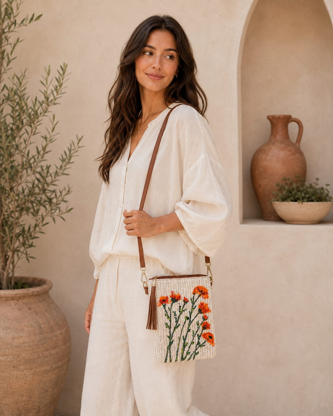 Model wearing hand-painted Poppies Multiple straw crossbody bag outdoors