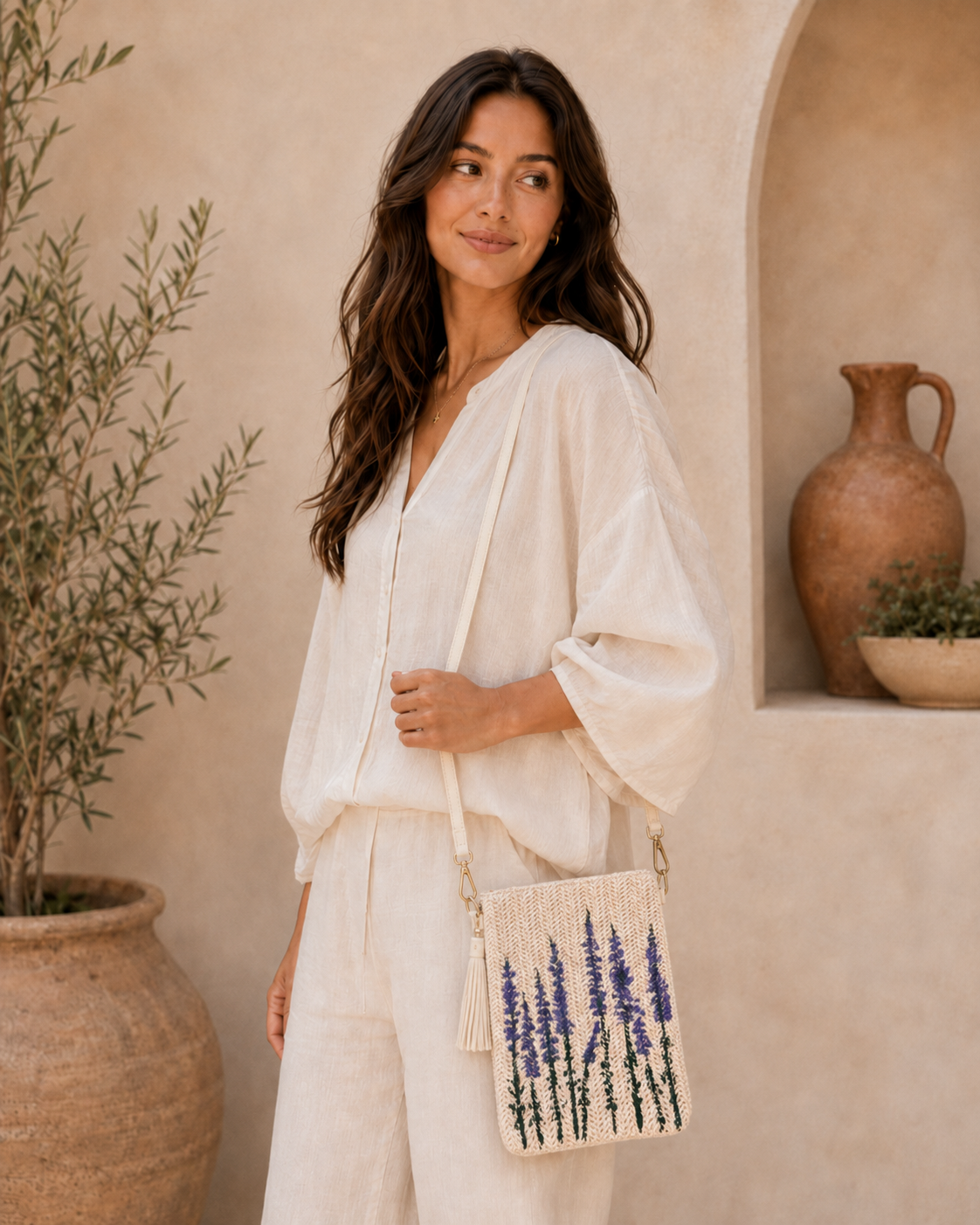 Model wearing hand-painted Lavender straw crossbody bag indoors