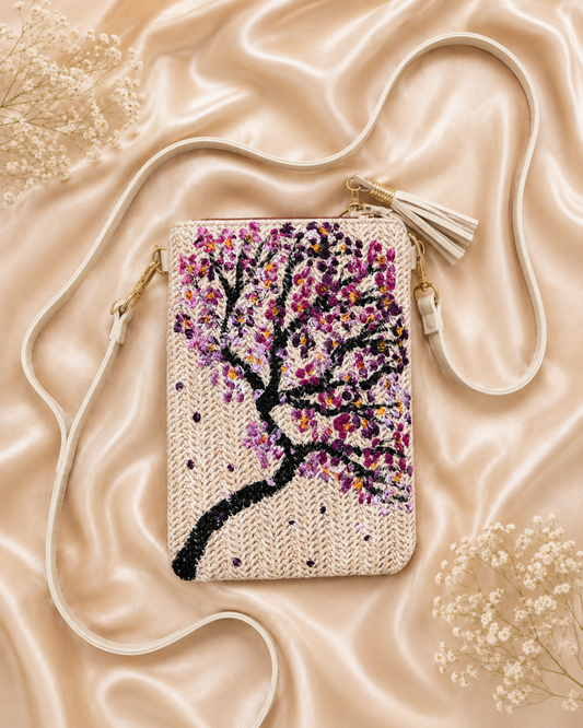 Hand-painted Cherry Blossom straw crossbody bag flat lay on silk fabric